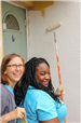 Photos of volunteers painting houses at NET event