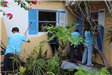 Photos of volunteers painting houses at NET event