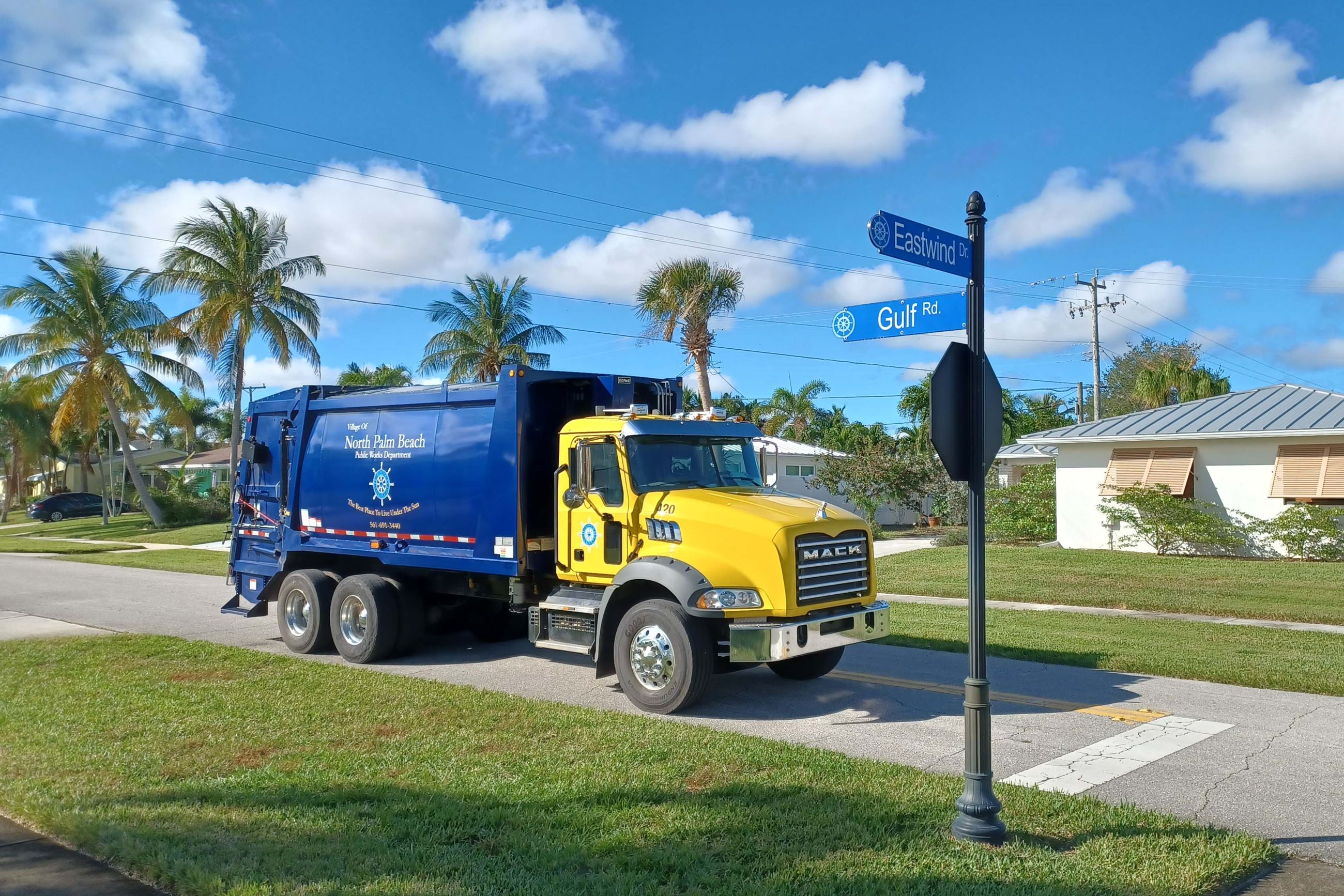 Garbage truck at street corner 1600x1067