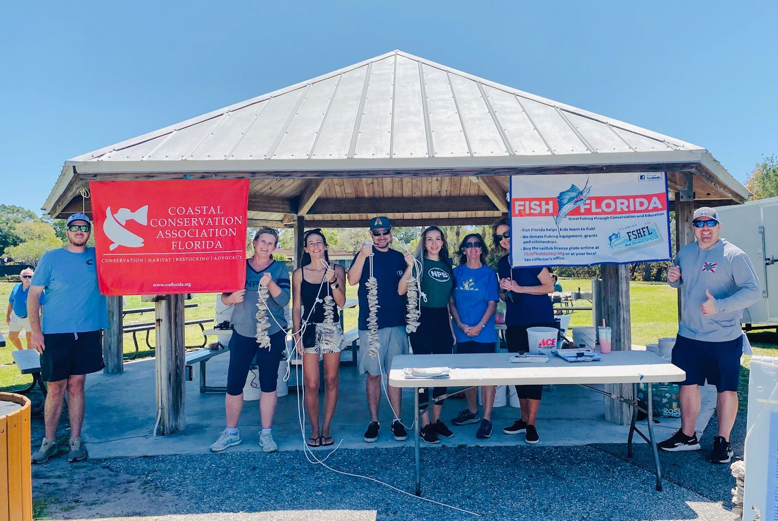 Several people holding up VOGs they made at Environmental Committee event